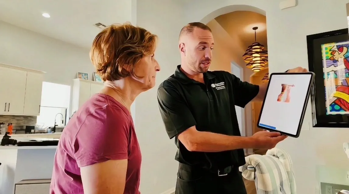 Dr. Yale Gordon showing a patient her INSiGHT neurologic scan results at home